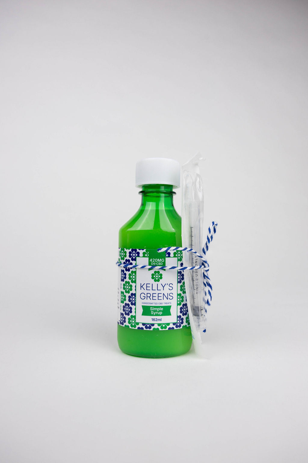 Bottle of THC and CBD infused simple Syrup with precision dropper