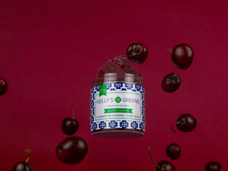 Jar of Wild Cherry gummies with vibrant red cherries cascading in the background