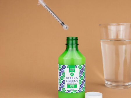 Precision dropper dispensing simple syrup into a glass of water