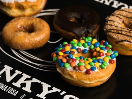 Assorted donuts with various glazes, frostings, and sprinkles
